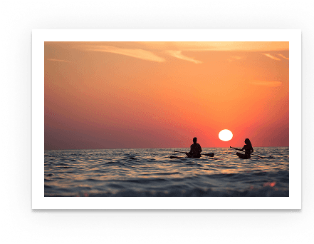 Sunset over water with people